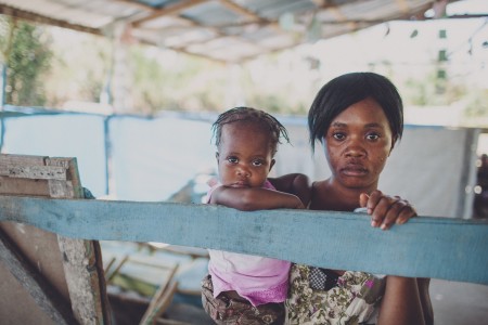 A mother and daughter patiently waiting at the medical clinic. 